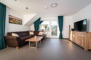 a living room with a couch and a tv at Landhaus Frese in Willingen