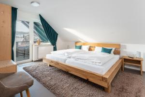 a bedroom with a large bed and a large window at Landhaus Frese in Willingen