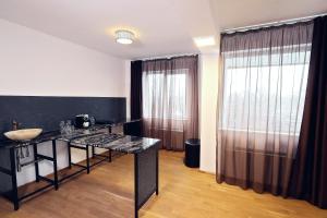 a room with a table and a large window at Living In Aparthotel in Oradea