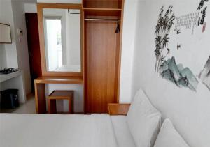 a bedroom with a bed and a window and a door at X-pressbedroom Vivo-Jogja in Seturan