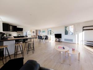 a large living room with a kitchen and a living room at La Tour de la Conterie in Beaumont-Village