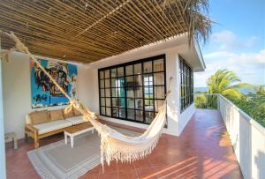 a hammock on the balcony of a house at Hotel Fenix Beach Cartagena in Tierra Bomba