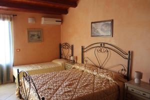 Кровать или кровати в номере Agorà-Akrai B&B