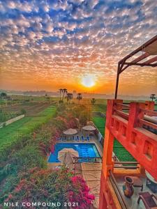 a view of a sunset from the balcony of a house at Nile Compound in Luxor