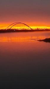 a bridge over a body of water at sunset at Zum Holzwurm in Mühlanger +1 photo