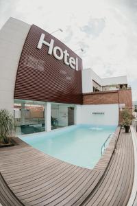 a hotel with a swimming pool in front of a building at Hotel Metropolitano in Coronel Fabriciano