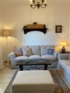 a living room with a couch and a table at PLENO CENTRO COMILLLAS-3 Hab, 2 Baños in Comillas