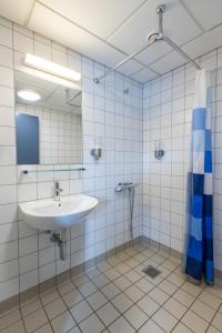 a bathroom with a sink and a mirror at HOTEL SØMA Nuuk in Nuuk