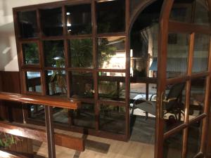 a room with a large glass door with a table at Wiener Haus Hotel in Piriápolis