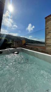 a jacuzzi tub with the sun in the background at Apartamento Aymara de StarApsTenerife in Sauzal