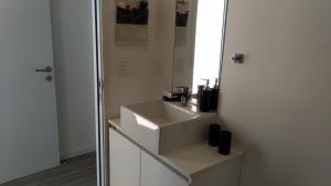 a bathroom with a sink and a mirror at PentHouse con fantástica vista y Amenities únicos in Punta del Este