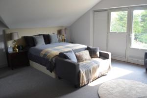 A bed or beds in a room at The Stone Barn at Stratton House 