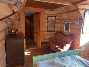 an attic room of a log cabin with a couch at Good Bye Lenin Hostel Zakopane in Zakopane