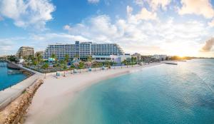 an aerial view of a beach with buildings and the ocean at Margaritaville Beach Resort Nassau in Nassau