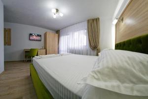 Postel nebo postele na pokoji v ubytování Bucovina Holidays Sadova