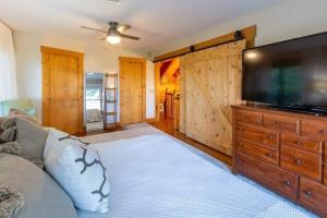 a living room with a large flat screen tv at Majestic Mountain Top, Best View in Bryson City! in Bryson City