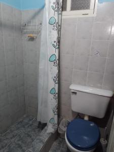 a bathroom with a toilet and a shower curtain at Cabañas La Caballeriza San Lorenzo in Salta