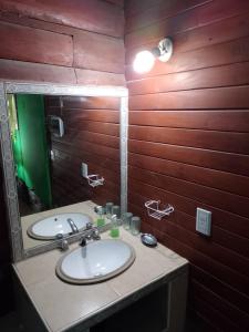 a bathroom with a sink and a mirror at Cabañas La Caballeriza San Lorenzo in Salta