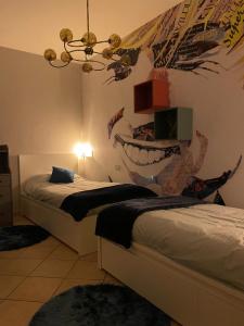 a bedroom with two beds and a mural of a shark at The Loft E&E Cinecittà in Empoli