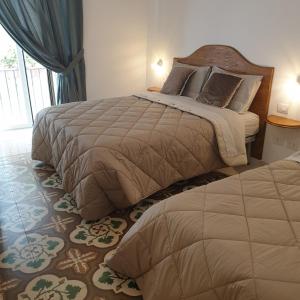 een slaapkamer met 2 bedden en een raam bij B&B Dei Cardinale in Bari
