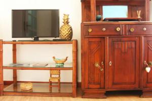 a room with a tv and a cabinet and a table at The Spot in Alfama in Lisbon