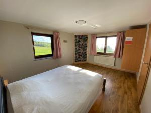Rúm í herbergi á Gite du Moulin Iris