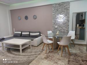 sala de estar con sofá, mesa y sillas en Lovely luxury apartment Sokratous 133, Kallithea, en Atenas