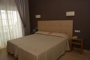 Posteľ alebo postele v izbe v ubytovaní Hotel Luz de Luna