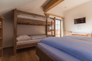 a bedroom with two bunk beds and a tv at Harrys Alm - Appartements in Haus im Ennstal