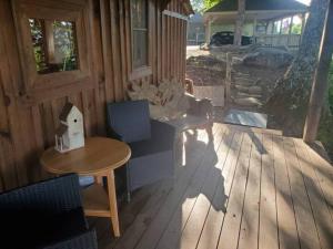 a patio with a table and chairs on a wooden deck at BEST VIEW IN BRYSON CITY IN THE SUGAR SHACK!! in Bryson City +8 photos