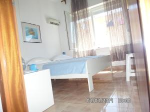 a bedroom with a bed in a room with a window at House Danica Apartments & Rooms in Sukošan
