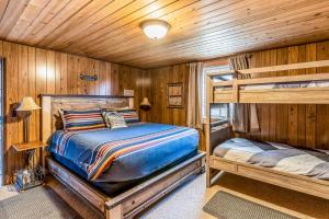 a bedroom with two bunk beds in a cabin at Bay Point Lakefront 1B Down in Whitefish +49 photos
