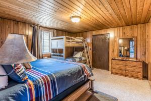 a bedroom with a bed and a bunk bed at Bay Point Lakefront 1B Down in Whitefish +21 photos