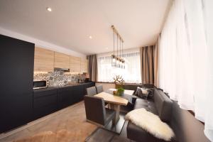 a living room with a couch and a table at K-Appartements Klösterle in Klösterle