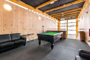 a room with a pool table and a couch at The Bealey Quarter in Christchurch