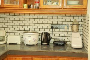 a kitchen counter with various appliances on it at Villa Green Heaven Hikkaduwa in Hikkaduwa