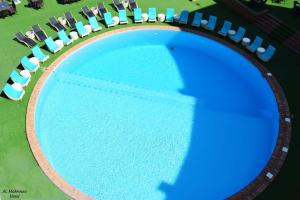 an overhead view of a swimming pool with lounge chairs at Fleet Club Mahrousa in Alexandria