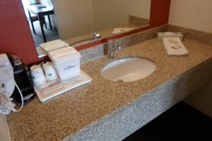 a bathroom counter with a sink in a hotel room at Howard Johnson by Wyndham Las Vegas near the Strip in Las Vegas