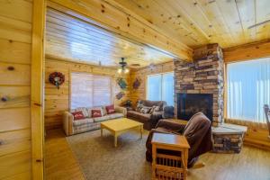 a living room with a fireplace in a log cabin at S`more Fun Cabin in Duck Creek Village