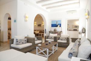 a living room with couches and a table at Hotel Villa Giulia in Porto Azzurro