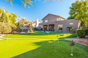a yard of a house with a putting green at Laguna Sonora in Phoenix