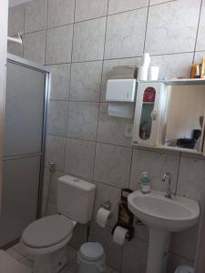 a small bathroom with a toilet and a sink at Hostel casa 1 in Araraquara +28 photos