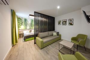 a living room with a couch and a bed at Wayteko Boutique Hotel in Alicante