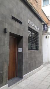 a entrance to a building with a brown door at EMBA ROOM in Madrid
