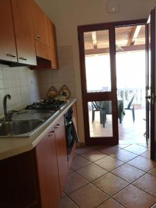 a kitchen with a stove and a door to a patio at Casale Villa Marzia in Massa Lubrense