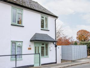 a white house with a black roof at 1 Sarnwen Cottages in Llanymynech