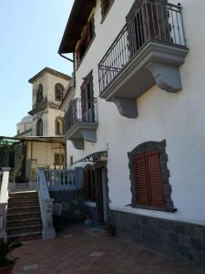 een wit gebouw met een trap en een klokkentoren bij Casale Villa Marzia in Massa Lubrense