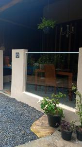 a view of a patio with a table and some plants at Canto do Sabiá PETAR Hospedagem Familiar in Iporanga