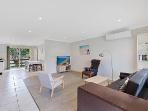 a living room with a couch and chairs and a table at Bonnieview House in Shelly Beach