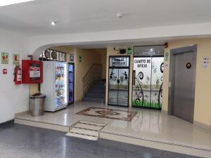 a gas station with two refrigerators and a staircase at Hotel Residencial Los Tres Pinos in Chiclayo